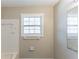 Bathroom featuring white tile, window to allow natural light, and neutral walls at 3884 Rockey Valley Dr, Conley, GA 30288