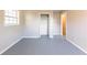 Bedroom with bi-fold closet, a light gray floor, one window, and neutral paint on the walls at 3884 Rockey Valley Dr, Conley, GA 30288