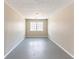 Bedroom featuring neutral paint, a window and painted concrete floor at 3884 Rockey Valley Dr, Conley, GA 30288
