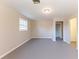 Spacious bedroom with neutral paint, gray floors, and a window providing lots of natural light at 3884 Rockey Valley Dr, Conley, GA 30288