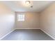 Bedroom with a standard ceiling light fixture and a single window that provides natural light at 3884 Rockey Valley Dr, Conley, GA 30288