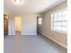Bright bedroom featuring neutral walls, light-colored flooring, and a window for natural light at 3884 Rockey Valley Dr, Conley, GA 30288