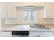 Bright kitchen with stainless steel sink, window with natural light, and dishwasher at 3884 Rockey Valley Dr, Conley, GA 30288