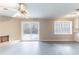 Inviting living room featuring a white brick fireplace and sliding glass doors to the patio at 3884 Rockey Valley Dr, Conley, GA 30288
