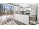 Modern kitchen featuring white cabinets, stainless steel appliances, and sliding door access to a wooden deck at 6746 Windfaire Dr, Norcross, GA 30093