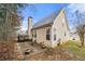 Back exterior showcasing a patio with seating, and partial siding at 11853 Harbour Town Pkwy, Fayetteville, GA 30215