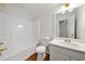 Bright bathroom featuring a tub/shower, a vanity with gold fixtures, and wood-look flooring at 11853 Harbour Town Pkwy, Fayetteville, GA 30215