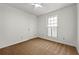 Well-lit bedroom with a large window, neutral carpet, and a closet at 11853 Harbour Town Pkwy, Fayetteville, GA 30215
