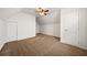 Large bedroom featuring neutral carpeting, a ceiling fan, and ample closet space at 11853 Harbour Town Pkwy, Fayetteville, GA 30215