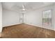 A main bedroom featuring carpet floors, white walls, and three large windows at 11853 Harbour Town Pkwy, Fayetteville, GA 30215