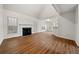 Spacious living room with hardwood floors, natural light, and a fireplace with white mantle at 11853 Harbour Town Pkwy, Fayetteville, GA 30215