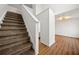 A staircase with carpet steps and a white banister leading to the upper level at 11853 Harbour Town Pkwy, Fayetteville, GA 30215
