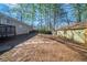 Backyard showing deck, trees, bare spots and wooden shed at 1433 Dennis Dr, Decatur, GA 30032