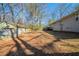 Large backyard with a combination of grassy and bare areas, along with some trees and plants at 1433 Dennis Dr, Decatur, GA 30032