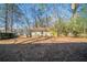 Large backyard with a wooden fence surrounding the perimeter and a storage shed in the back at 1433 Dennis Dr, Decatur, GA 30032