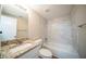 The bathroom features a granite-topped vanity and a shower-tub combination with stylish marble-look tiling at 1433 Dennis Dr, Decatur, GA 30032