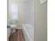 This bathroom showcases a marble-look tiled shower-tub combination with a white tub at 1433 Dennis Dr, Decatur, GA 30032