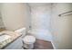 Updated bathroom featuring tub-shower, white vanity with granite countertop, and wood-look floors at 1433 Dennis Dr, Decatur, GA 30032