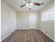Cozy bedroom featuring wood floors, a ceiling fan, and two closets for ample storage at 1433 Dennis Dr, Decatur, GA 30032