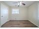 Clean bedroom with wood floors, neutral walls, a ceiling fan, and natural lighting from the window at 1433 Dennis Dr, Decatur, GA 30032