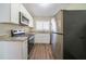 Modern kitchen with stainless steel appliances, granite countertops, and sleek white cabinets at 1433 Dennis Dr, Decatur, GA 30032