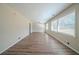 Spacious living room featuring wood floors, a ceiling fan, and lots of natural light from the windows at 1433 Dennis Dr, Decatur, GA 30032