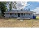 Backyard featuring a gray painted brick house with a well kept lawn at 1925 Campbellton Sw Rd, Atlanta, GA 30311