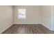 Cozy bedroom featuring hardwood floors and a bright window at 1925 Campbellton Sw Rd, Atlanta, GA 30311