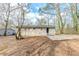 Back of home with concrete patio and yard at 3192 Belfort Se Rd, Atlanta, GA 30354