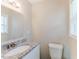 A bathroom features a toilet, window with blinds and granite topped sink at 3192 Belfort Se Rd, Atlanta, GA 30354