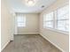 A carpeted bedroom features windows with mini blinds, and a light neutral color at 3192 Belfort Se Rd, Atlanta, GA 30354