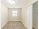 A carpeted bedroom features a window for natural light and closet for storage at 3192 Belfort Se Rd, Atlanta, GA 30354