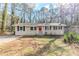 Charming one-story home with a red front door and a well-maintained lawn at 3192 Belfort Se Rd, Atlanta, GA 30354