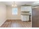 Eat-in kitchen boasts stainless steel appliances, granite countertops, and modern lighting at 3192 Belfort Se Rd, Atlanta, GA 30354