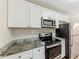 Well-equipped kitchen with stainless steel appliances, granite counters, and sleek cabinetry at 3192 Belfort Se Rd, Atlanta, GA 30354