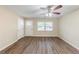 Bright living room featuring laminate floors, a ceiling fan, and ample natural light at 3192 Belfort Se Rd, Atlanta, GA 30354