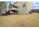 Expansive backyard with a covered patio, upper level deck with an enclosed porch and lush green surroundings at 3680 Falling Leaf Ln, Cumming, GA 30041