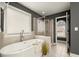 Contemporary bathroom featuring a freestanding tub, glass enclosed shower, and modern fixtures at 3680 Falling Leaf Ln, Cumming, GA 30041