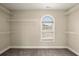 Walk-in closet with adjustable shelving and a window, offering ample storage at 3680 Falling Leaf Ln, Cumming, GA 30041