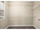 Walk-in closet with adjustable shelving and natural light from a window, offering ample storage at 3680 Falling Leaf Ln, Cumming, GA 30041