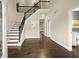 Bright foyer with a staircase, hardwood floors, high ceilings, and an open view of the upper level at 3680 Falling Leaf Ln, Cumming, GA 30041