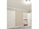 Hallway with view of stairs features neutral walls, white trim and doors, and overhead lighting at 3680 Falling Leaf Ln, Cumming, GA 30041