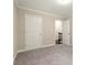 Hallway with view of stairs features neutral walls, white trim and doors, and overhead lighting at 3680 Falling Leaf Ln, Cumming, GA 30041