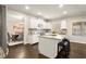 Modern kitchen with a center island, granite countertops, stainless steel appliances, and hardwood floors at 3680 Falling Leaf Ln, Cumming, GA 30041