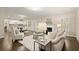 Open-concept living room with white fireplace, modern furnishings, and seamless flow to the kitchen at 3680 Falling Leaf Ln, Cumming, GA 30041