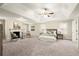 Spacious main bedroom features a tray ceiling, fireplace, sitting area, and neutral decor and large windows at 3680 Falling Leaf Ln, Cumming, GA 30041