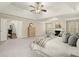Spacious main bedroom features a tray ceiling, fireplace, sitting area, and neutral decor at 3680 Falling Leaf Ln, Cumming, GA 30041