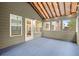 Relaxing screened-in porch with a blue carpet, exposed beams and abundant windows at 3680 Falling Leaf Ln, Cumming, GA 30041