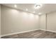 View of an interior room with neutral walls, recessed lights, base molding and wood-look flooring at 3680 Falling Leaf Ln, Cumming, GA 30041