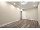 Interior room with neutral walls, recessed lights, base molding and wood-look flooring and white door at 3680 Falling Leaf Ln, Cumming, GA 30041